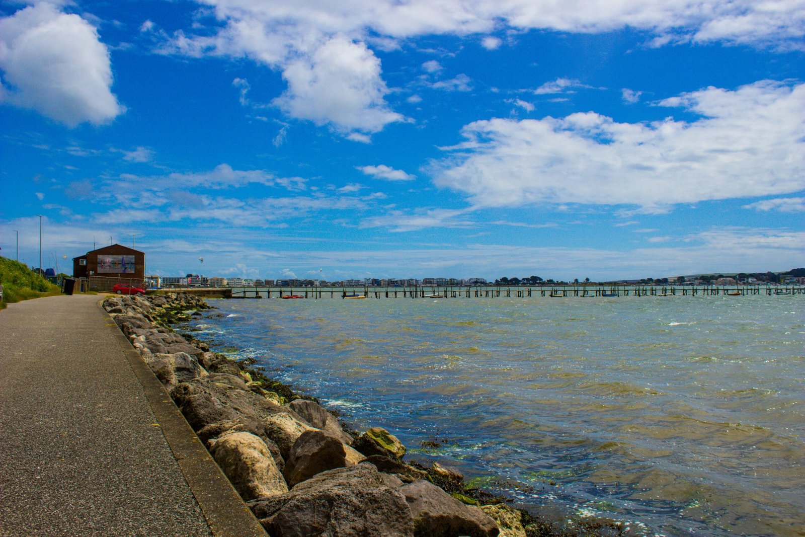 A view of a body of water with a bridge in the background